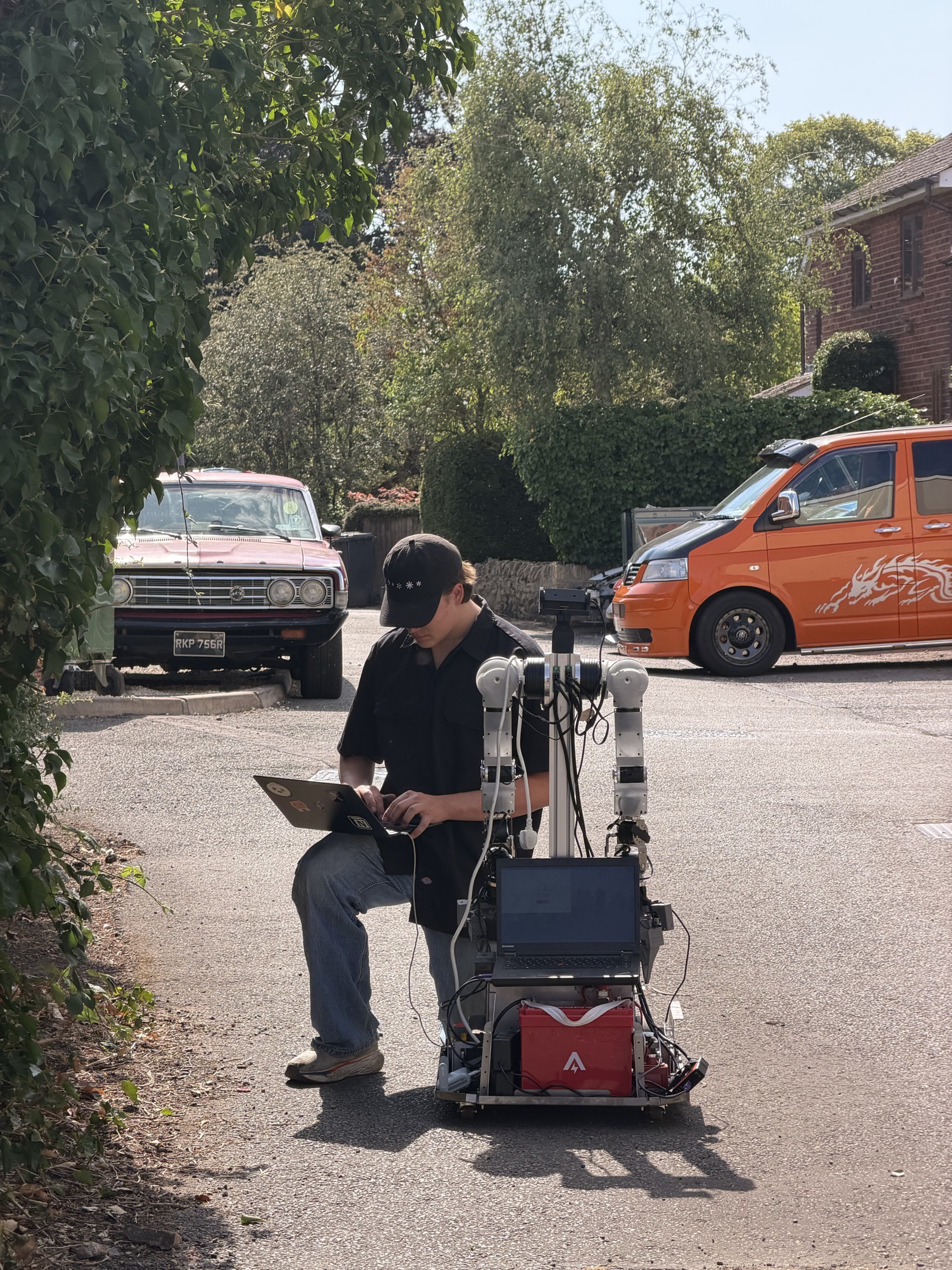 A foak prototype beside a team member outside a garage